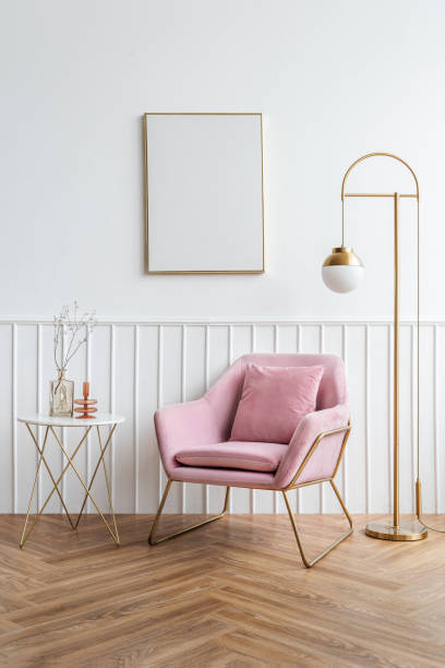 istock Blank picture frame by a pink velvet armchair 2156434714