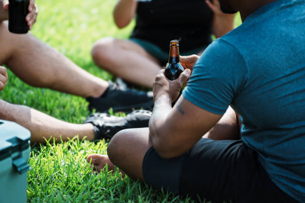istock Unrecognizable man drinking beer with friends outside 2156436953