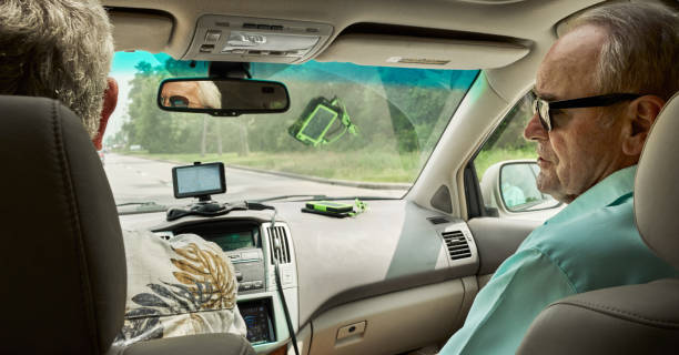 istock Mature men powering their GPS device with a solar charger during a drive 2156439046