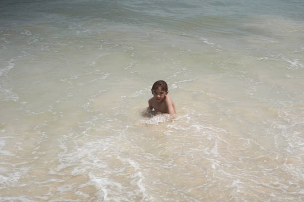 istock children playing in the sea at the beach 2156439392