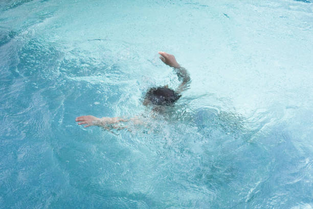 istock Child boy Diving in the swimming pool 2156439469