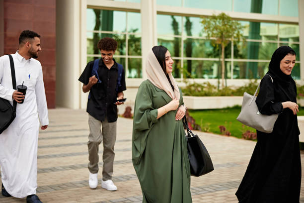 istock Male and female Saudi students walking in campus 2156439516