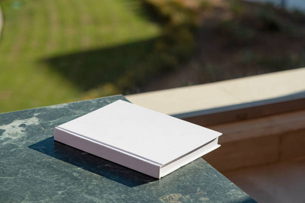 istock blank book mockup on green marble stone coffee table , shadow overlay 2156442379