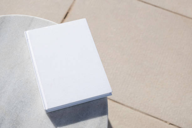 istock blank book for mockup design on marble table by the swimming pool 2156442594
