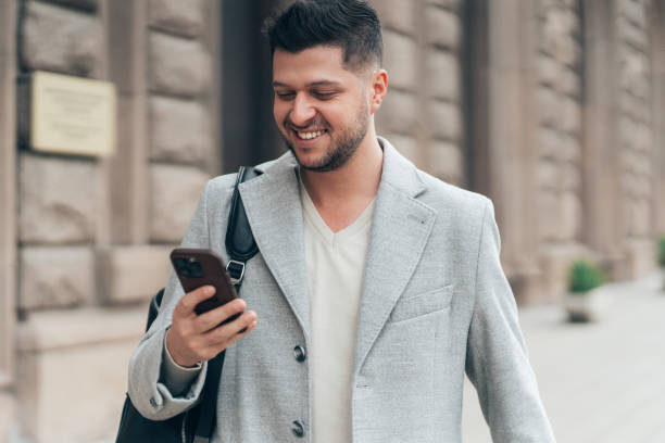 istock Texting in the city street. 2156444351