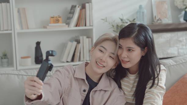 istock Asian LGBTQIA young couple having fun vlogging at home 2156446421