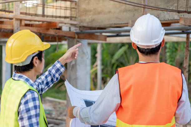 istock inspector or engineer is inspecting construction and quality assurance new house using a blue print. Engineer or architects or contactor work to build the house before handing it over to the homeowner 2156446679