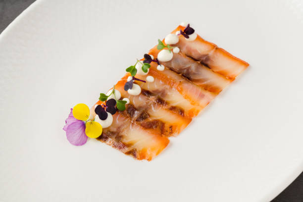 istock Smoked fish pastrami or bacon on a white porcelain plate 2156446738