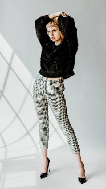 istock Woman in a fluffy sweater posing mobile phone wallpaper 2156446794