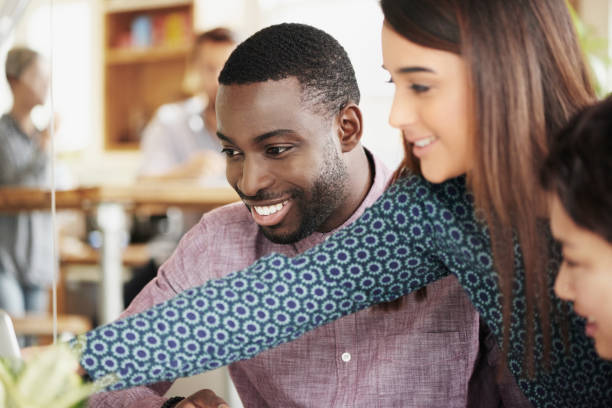 istock Innovation, team work or creative people in a meeting planning ideas for our vision or startup development. Collaboration, leadersip or woman pointing at research or strategy with graphic designers 2156449408