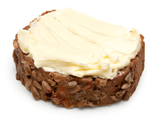 istock freshly baked dark bread with butter isolated on white background. clipping path 2156450456