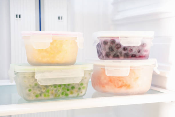 istock Vegetables and berries in glass boxes in the freezer close-up. 2156450944