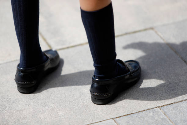 istock child's legs with high socks and moccasins 2156451188