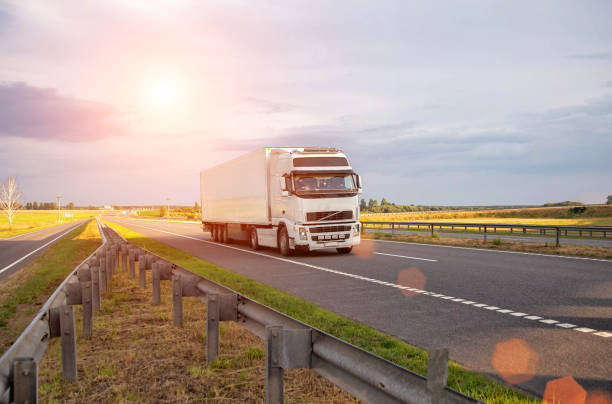 istock A white modern truck with an isothermal refrigerated semi-trailer transports perishable products in a trailer with a constant temperature regime. Transportation of seafood, fruits and meat. Copy space for text, sunset 2156452012