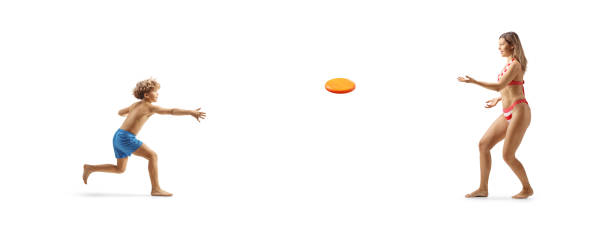 istock Woman in bikini playing with a boy and throwing a plastic disc 2156452108