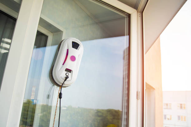 istock Automatic vacuum robot window cleaner washes glass in the apartment, balcony frame, 2156453600