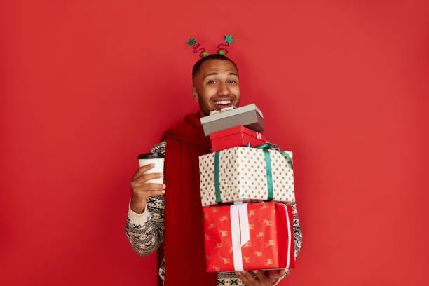 istock Happy Man Holding Present. Guy Holding in Coffee to Go and Present Box 2156454098