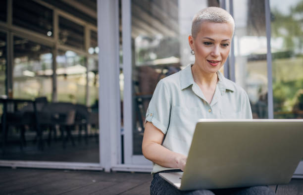 istock Businesswoman working remotely outdoors on the laptop 2156454162