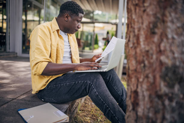 istock Businessman working remotely outdoors on the laptop 2156454217