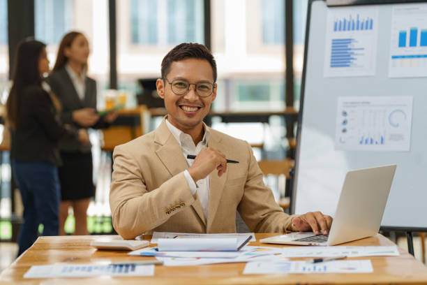 istock Asian businessman working with a laptop in an office. 2156454851
