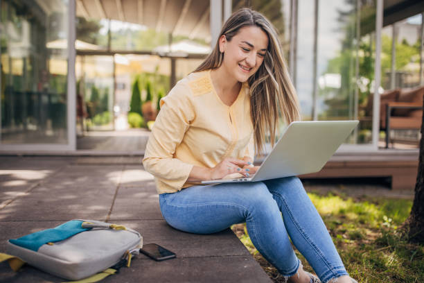 istock Businesswoman working remotely outdoors on the laptop 2156455492
