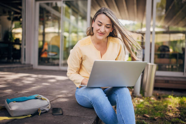 istock Businesswoman working remotely outdoors on the laptop 2156455505