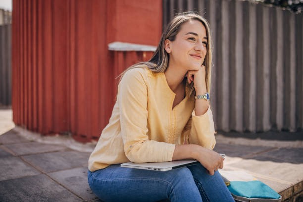 istock Businesswoman working remotely outdoors on the laptop 2156455668