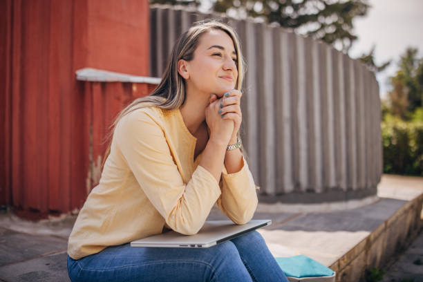 istock Businesswoman working remotely outdoors on the laptop 2156455688