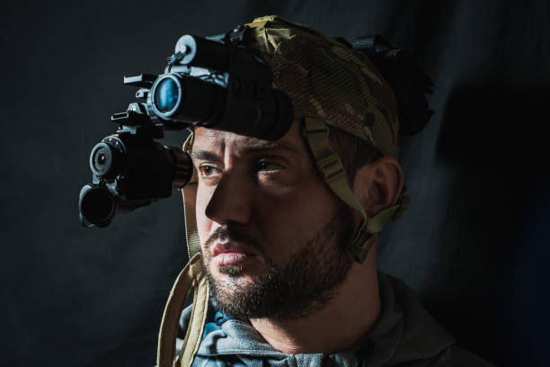 istock Portrait of a military man with a beard with a binocular night vision device on his head. 2156456486