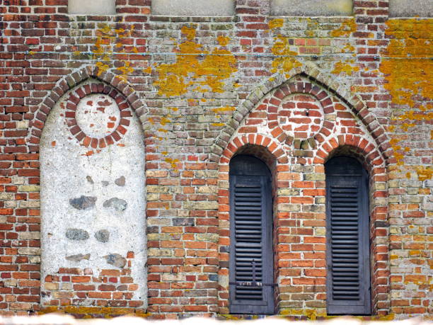 Church facade detail captures historic window structures, revealing architectural beauty and cultural heritage of the building