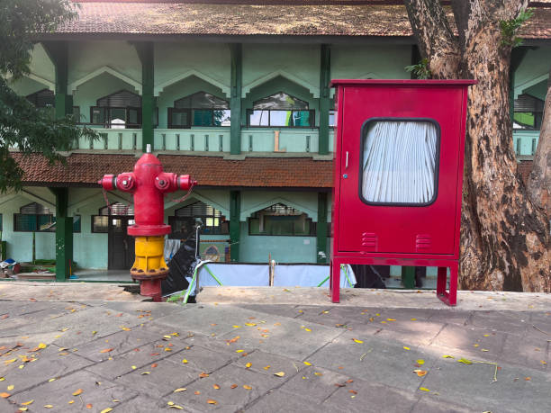 istock fire hydrant and fire hose reel at outdoor 2156460077