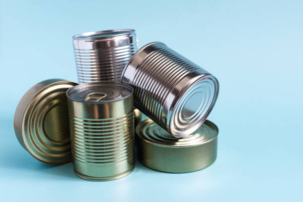 istock Tin cans with various products in close-up on a colored background. Long-term storage products. 2156460626