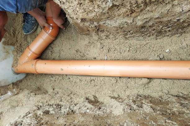 istock A locksmith supplies a sewer pipe to the sump. 2156463807
