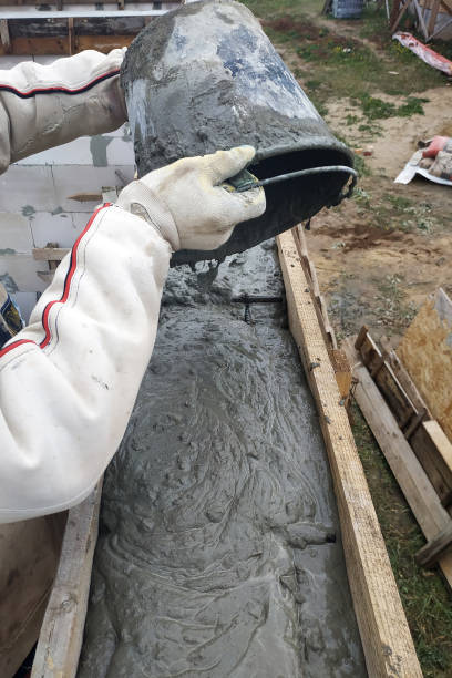 istock The worker pours a bucket of cement into the formwork. 2156464060