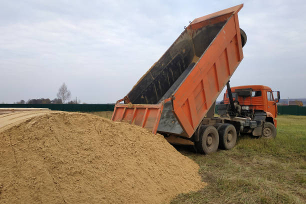 istock A large orange dump truck unloads the sand 2156464382
