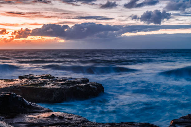 istock Sunrise, sea, waves, clouds and tessellated rock platform 2156464900
