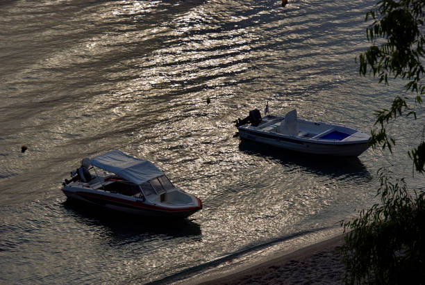 view of boats on the sea with reflected light in Parga
