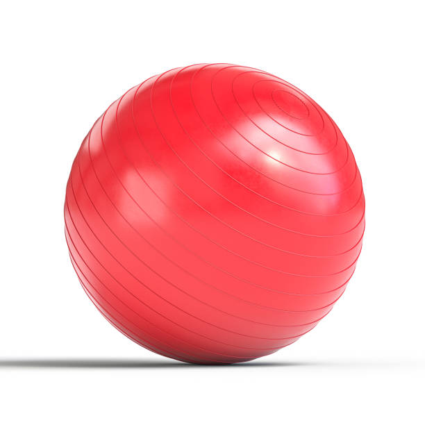 Red fitness ball balancing on white background