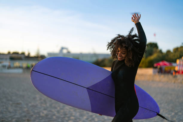 istock Joyful Black Female Surfer With Board on Beach 2156467765