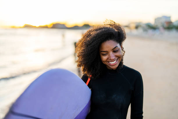 istock Joyful Black Female Surfer With Board on Beach at Sunset 2156467780