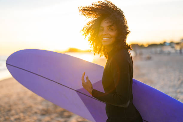 istock Joyful Black Female Surfer with Board on Beach 2156467785