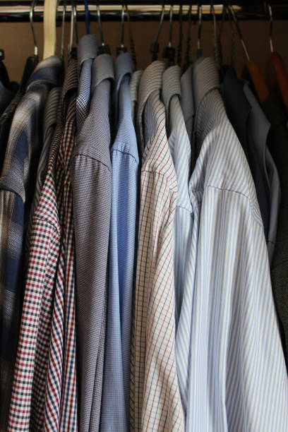 istock High wardrobe compartment with classic shirts on flocked hangers 2156468033
