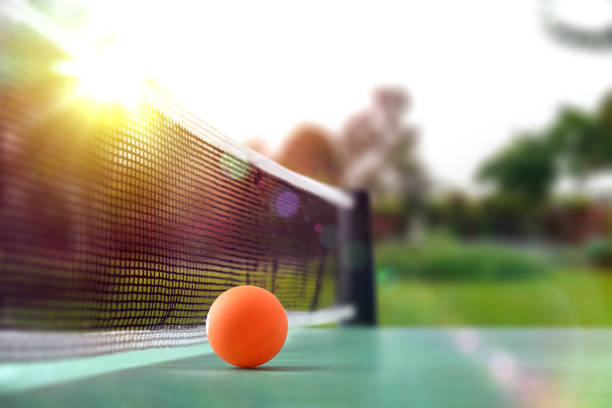 istock Ping-pong game with ball on green table with nature background 2156469001