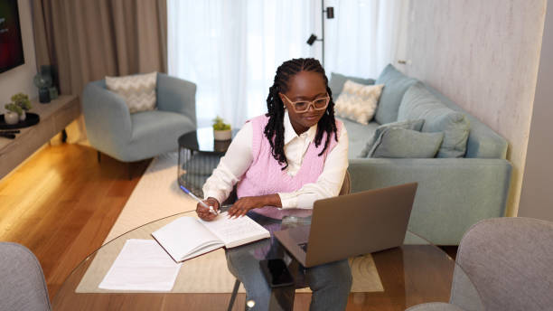 istock Young, happy woman planning her online work 2156469175