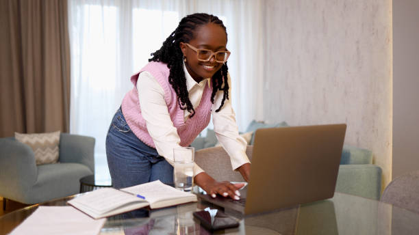 istock Happy young woman working online with her clients 2156469271