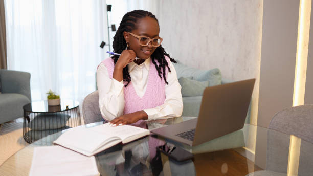 istock Happy young woman working online with her clients 2156469593
