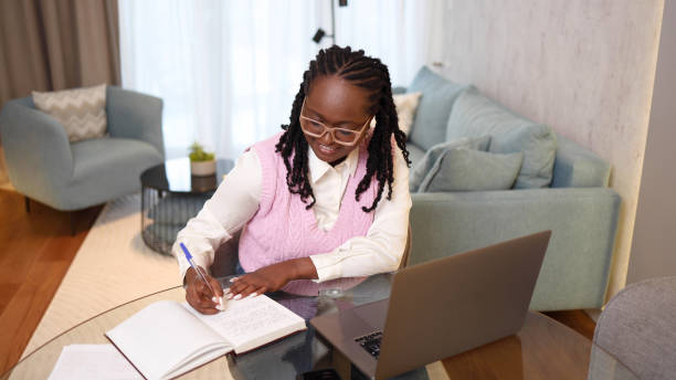istock Happy young woman working online with her clients 2156469710