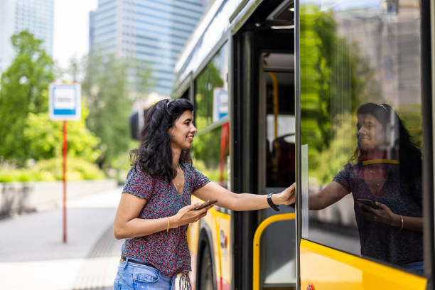 Young woman entering a city bus