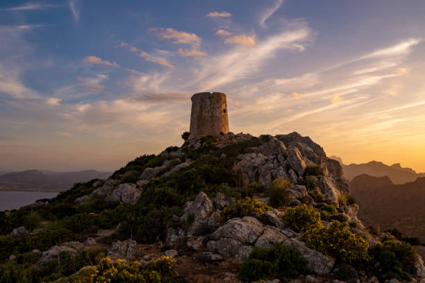 View of Talaia de Albercutx ancient watchtower at sunset, located in a high look point of Formentor Peninsula, Majorca, Balearic Islands, Spain