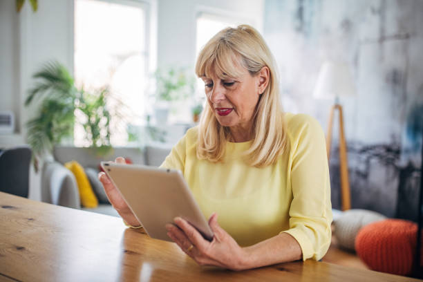istock Senior white woman typing on a tablet 2156476562